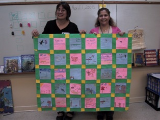 SK and Ms. Agrelot hold quilt