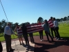 FIU students lower the flag at the Normandy American cemetery